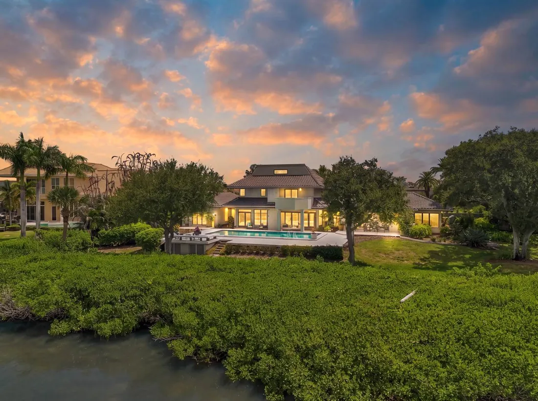 Aerial view at dusk of 722 Loggerhead Island Drive and its pool on the Banana River