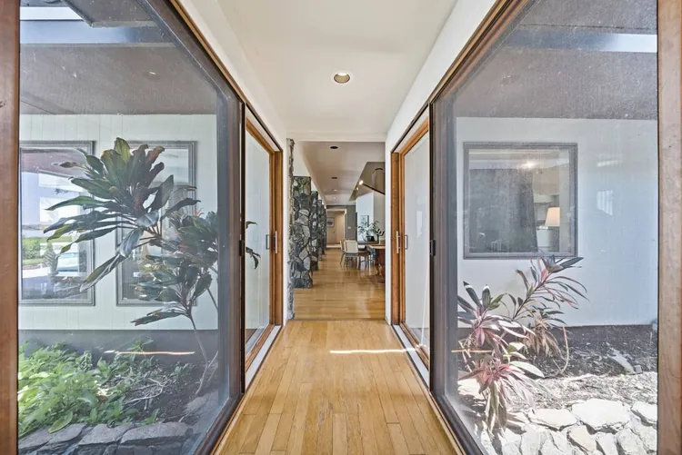 Glass corridor overlooking interior plantings